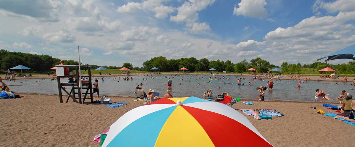 Swim pond with multi color sun umbrella