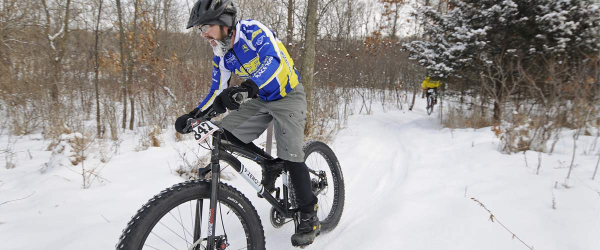 a mountain biker on a snowy trail