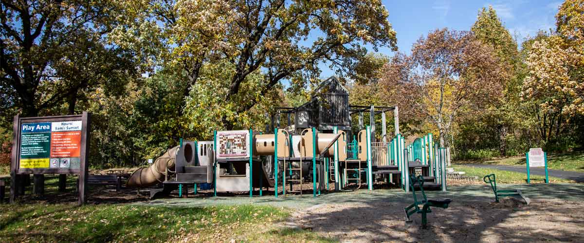 A small tan and green play area in the fall.