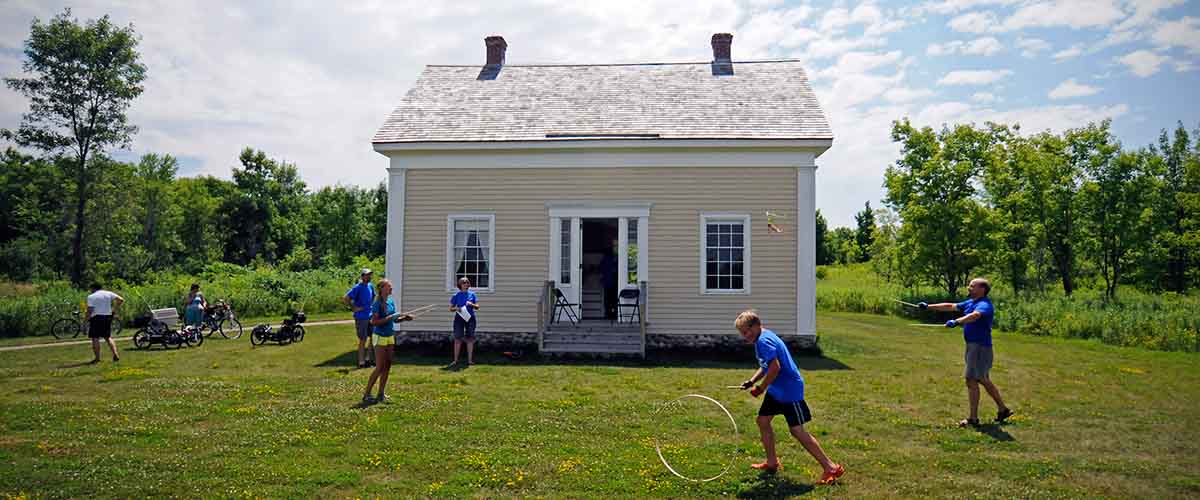 Children playing hoops in front of Historic Pierre Bottineau House