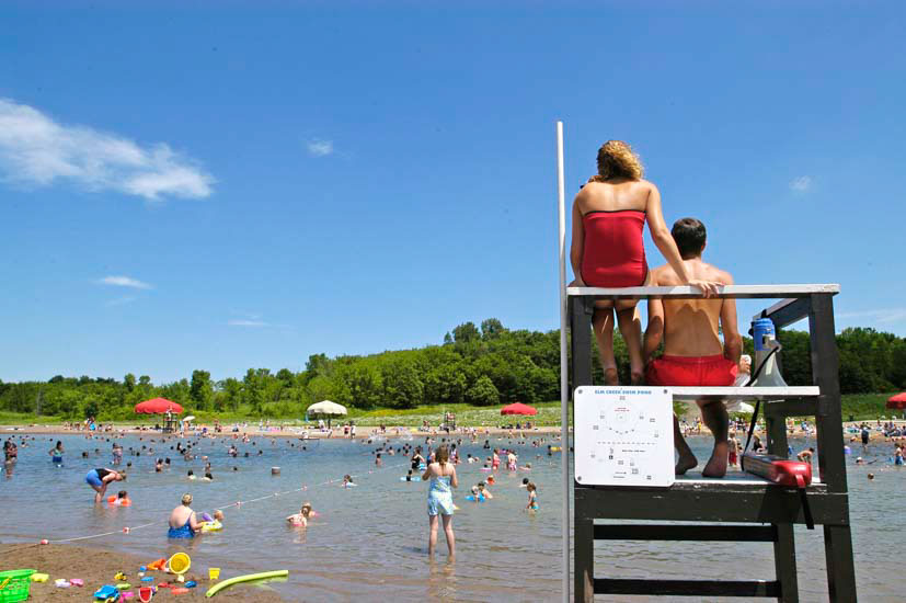 Lifeguards observing people swimming in a swim pond