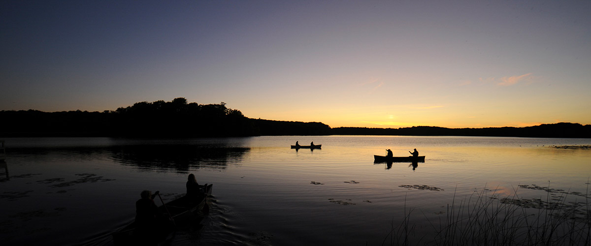 Canoes on the lake at sunset