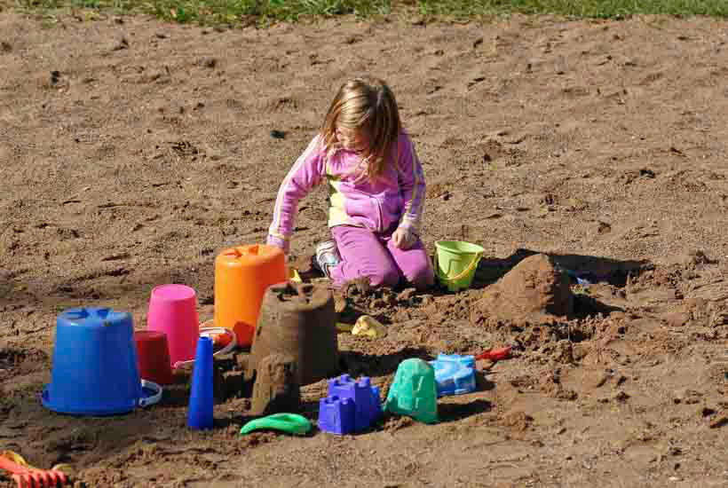 Girl playing in beach sand
