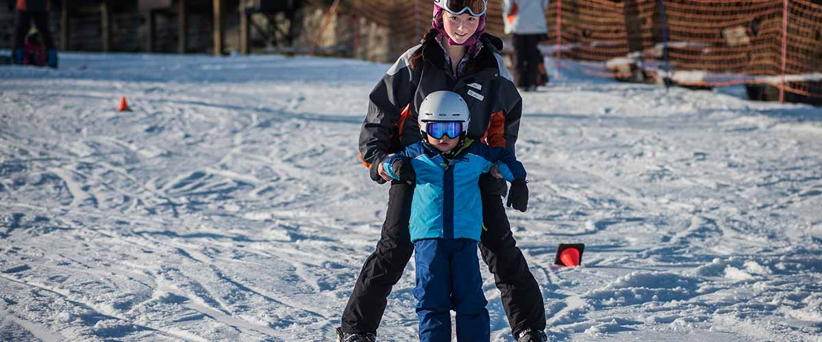 Instructor with young skier