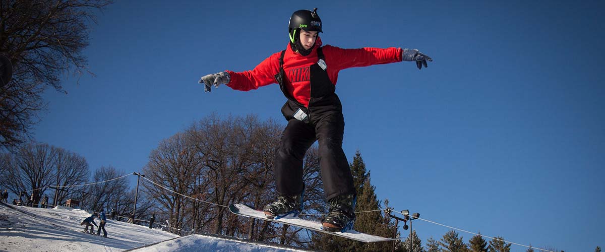 Snowboarder coming off a jump