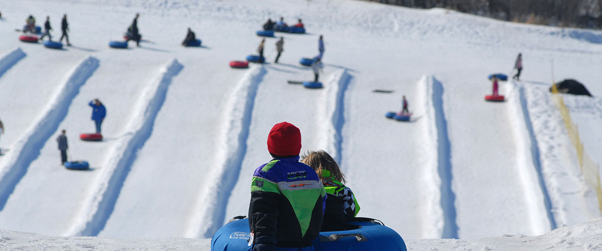 Children waiting at the top of the tubing hill