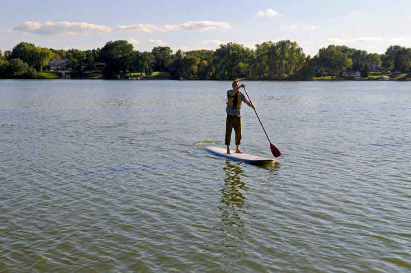 A man stands on a paddle board