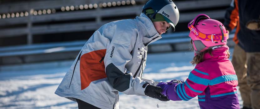 ski instructor teaching child