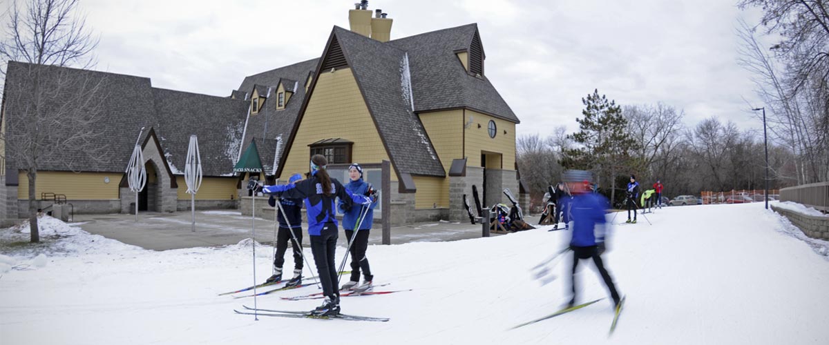 cross-country skiiers outside of the Hyland Visitor Center