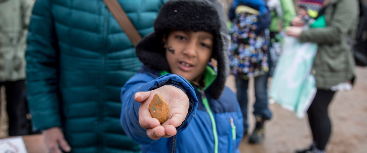boy holding rocks