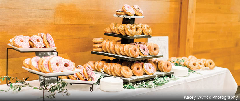 A table set with tiered trays of donuts.