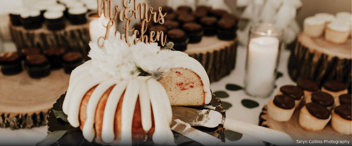 A bundt cake sits on a dessert table at an event.