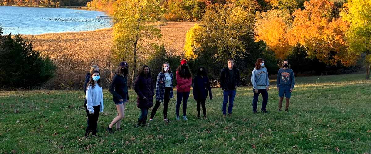 The Three Rivers Teen Council poses for a picture at Gale Woods Farm in the fall. All members are wearing masks.