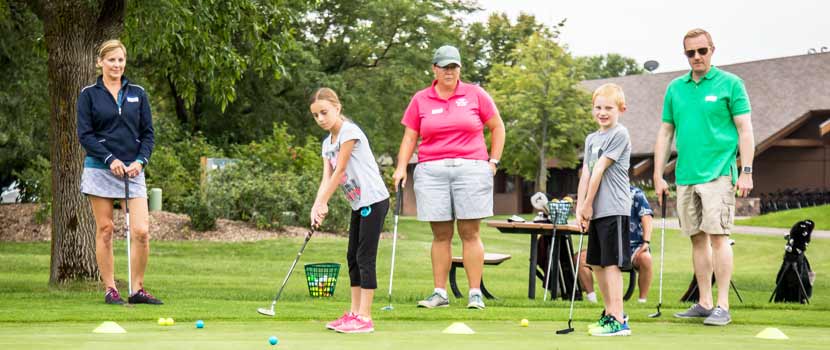 Two children practice golfing with Three Rivers Parks staff.