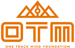 One Track Mind Foundation logo, with triangles resembling mountains in orange outline above OTM in orange and One Track Mind Foundation below