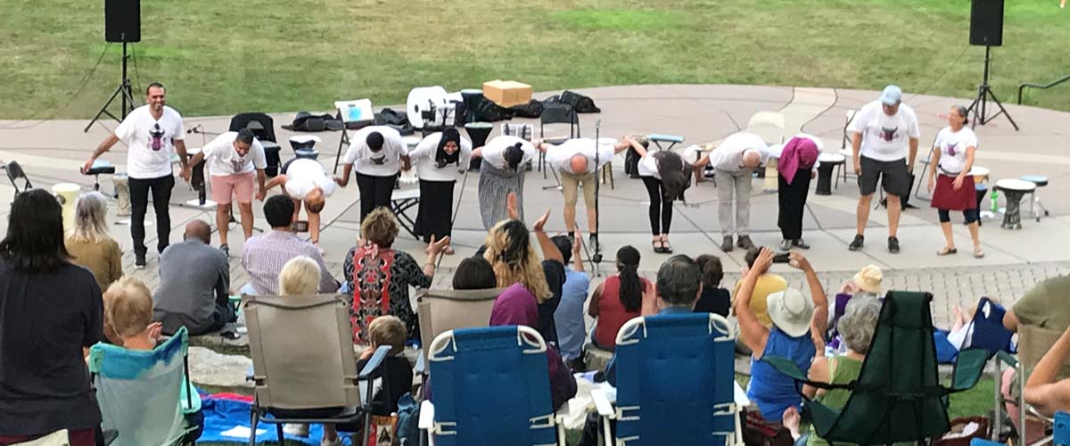 Performers bow to a clapping and cheering crowd at Silverwood Park.