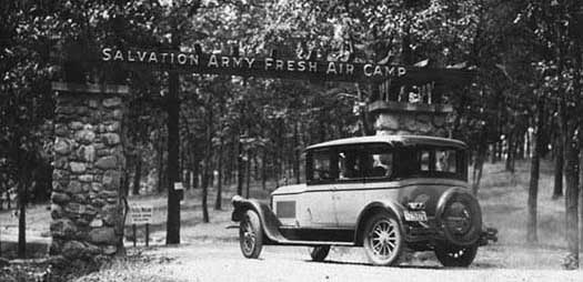 Photo of a car in front of the sign for the Salvation Army Fresh Air Camp entrance. Courtesy of Minnesota Historical Society.