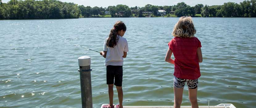 Two children fish from a dock on Silver Lake.