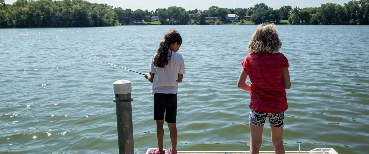 Two children fish from a dock on Silver Lake.