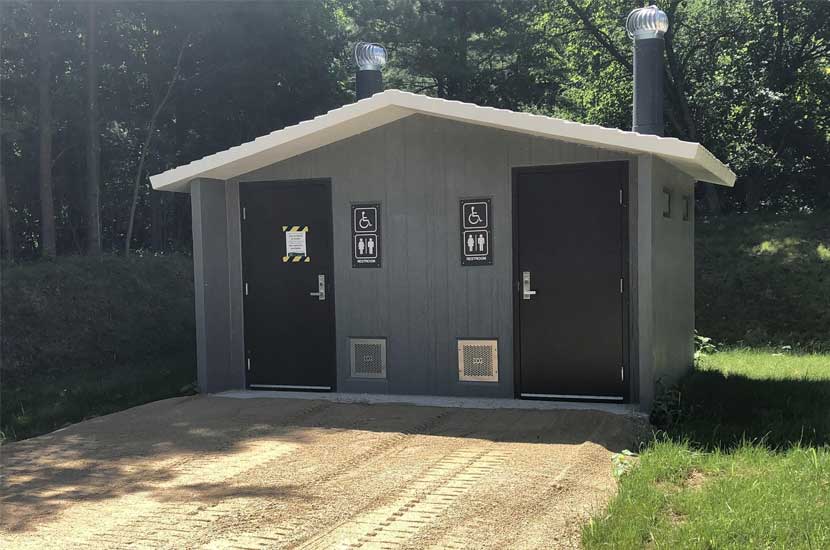 A latrine toilet with two doors.