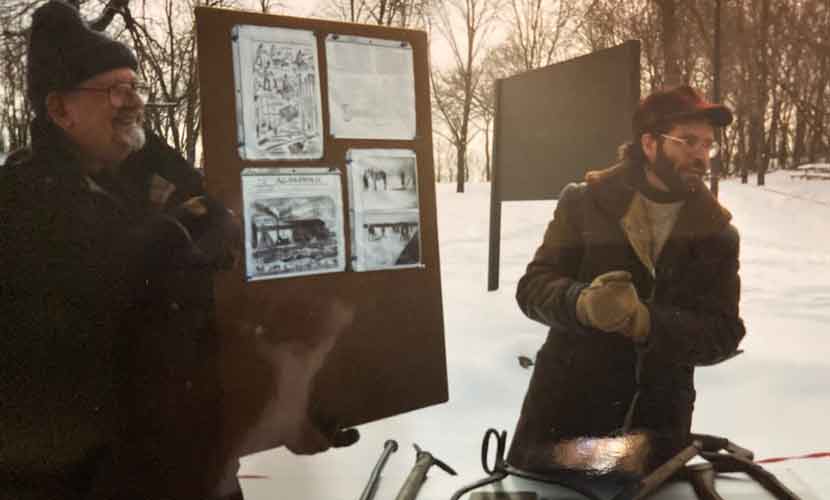 Tim Graf and a volunteer explain ice harvesting tools from land due to slushy conditions on the lake at the first event in 1999.