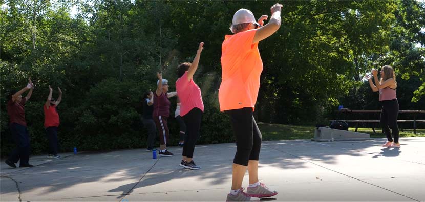 Participants in the Senior Latino Engagement group do Zumba outside at Fish Lake Regional Park.