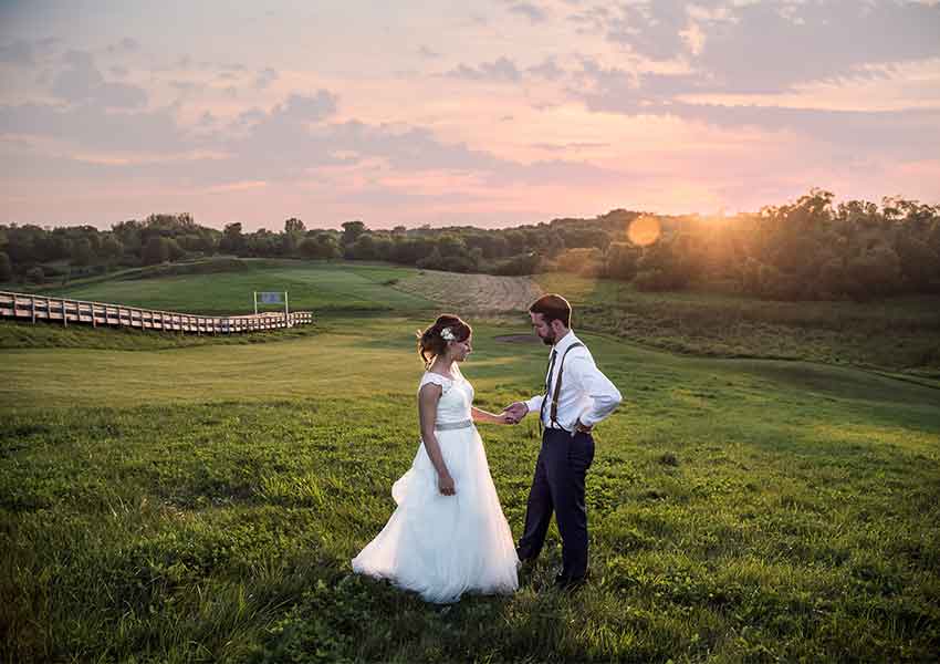 bride and groom with rolling hills in the background