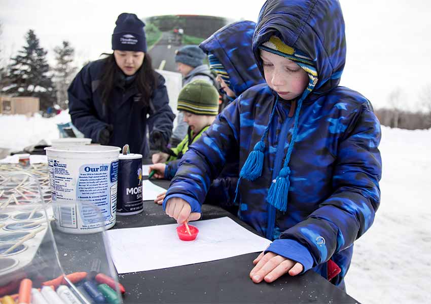 kid using ice to make winter art