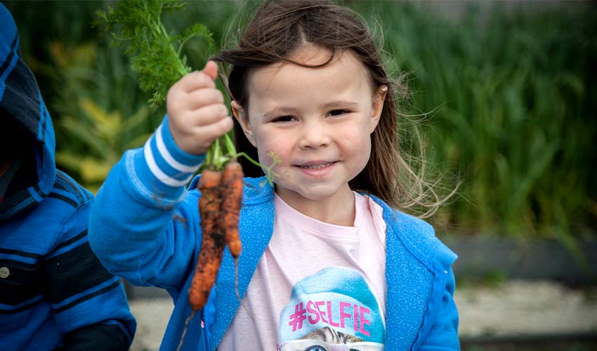 girl holding carrots