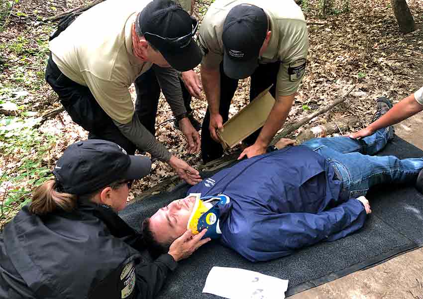 Lori and two park service assistants practicing emergency rescue in a simlulation. 