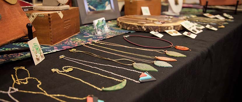 artisan necklaces displayed on a table