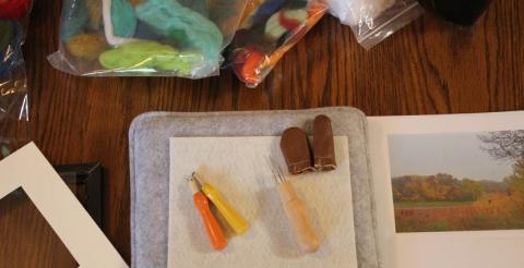 Photo of tools for dry felting on a table.